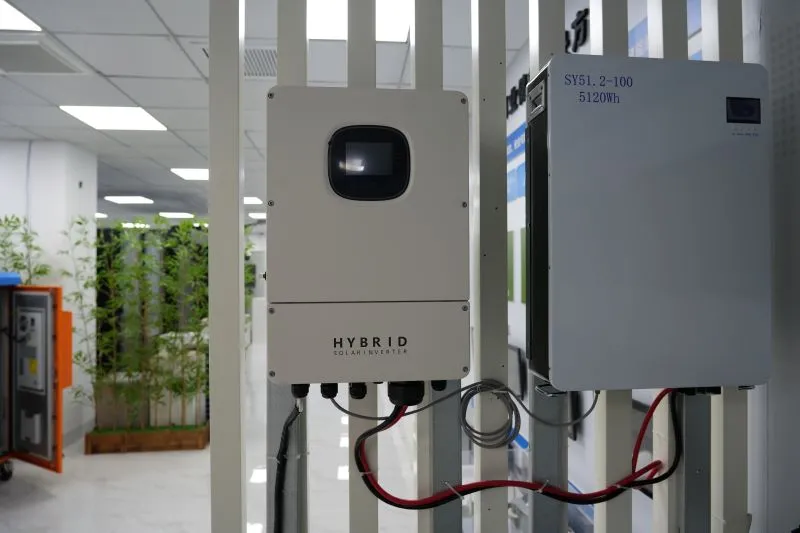 Two hybrid inverters mounted on a white wall.