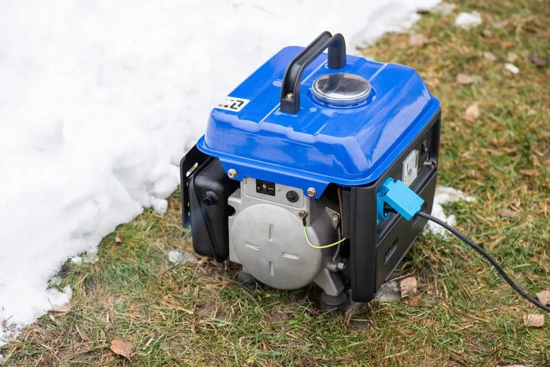 Portable solar power generator with foldable solar panels in a camping setup